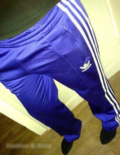 Adidas womans blue pants with white stripe tilted close angle shot small logo