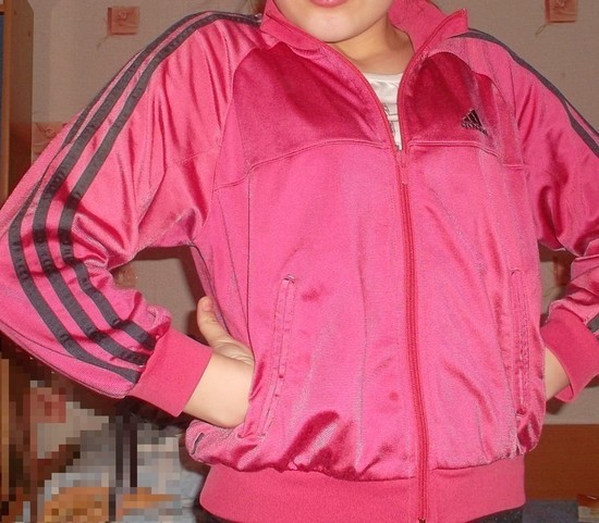Adidas womans full pink jacket with black trim pocket pose