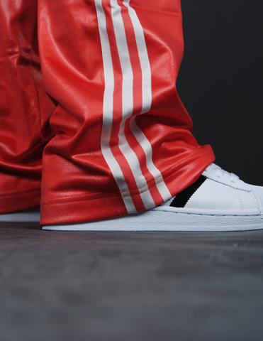 Adidas womans red pants white stripes close up ankle shot