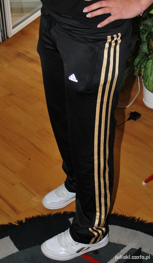 Adidas womens black pants gold stripe angle stand pose