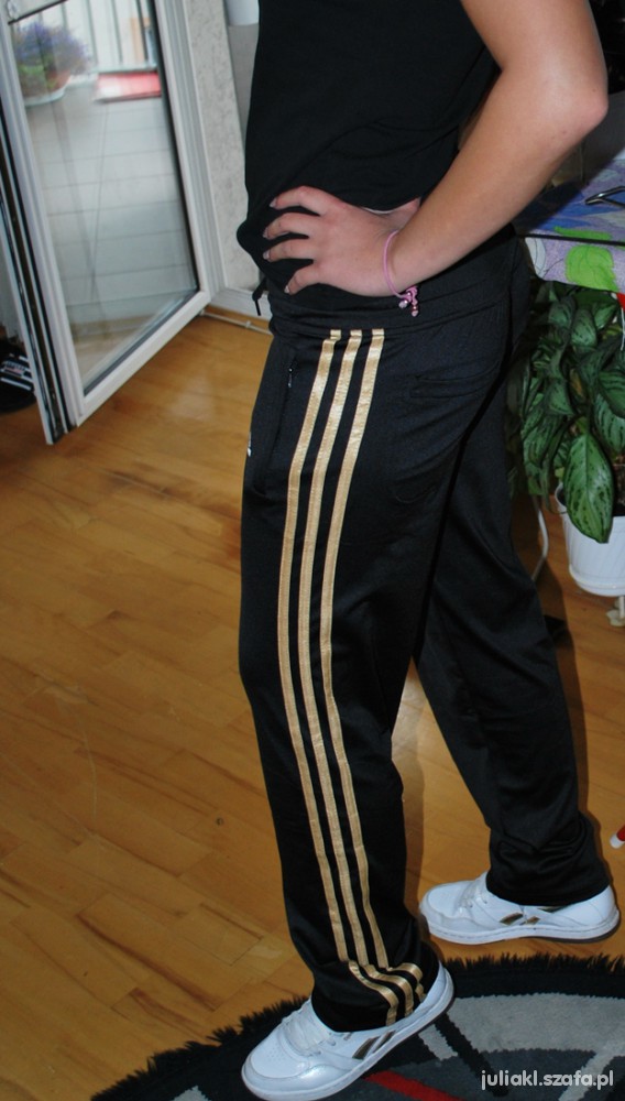 Adidas womens black pants gold stripe side hip pose