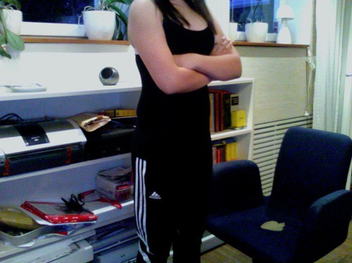 Adidas womens black pants with black tank top arms crossed pose