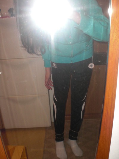 Adidas womens black pants with white stripes front camera flash shot