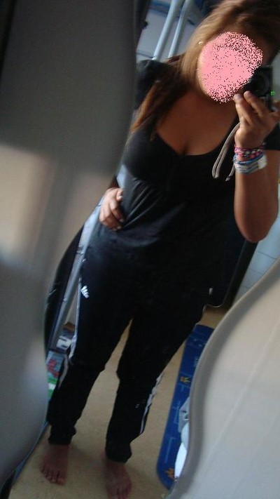 Adidas womens black pants with white stripes tilted front angle shot with black top