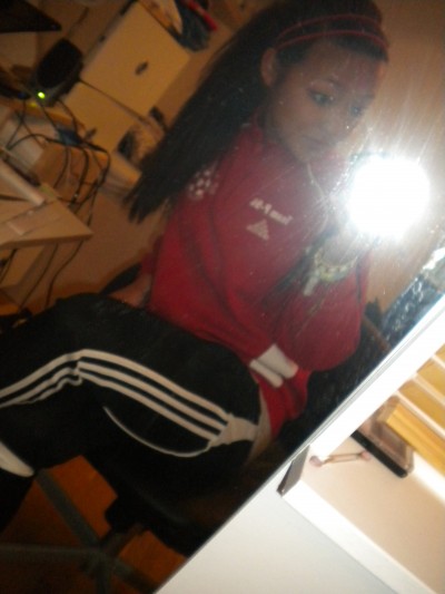 Adidas womens black pants with white trim sitting angle