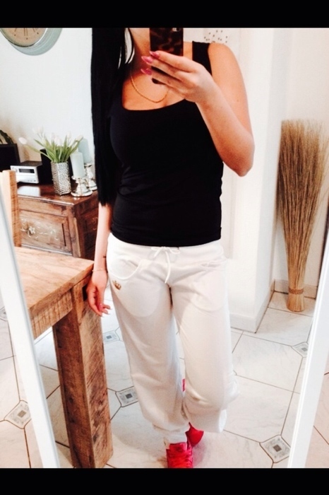 Girl in adidas white pants