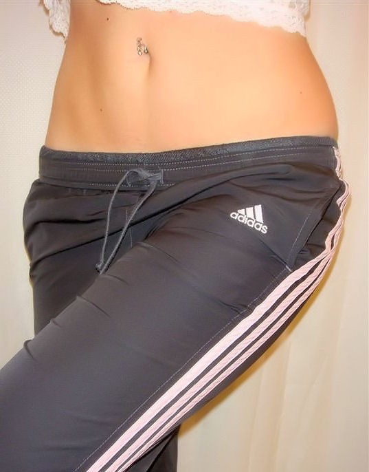 Girl in black and white Adidas pants