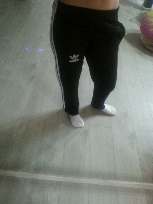 Girl in black/white Adidas pants