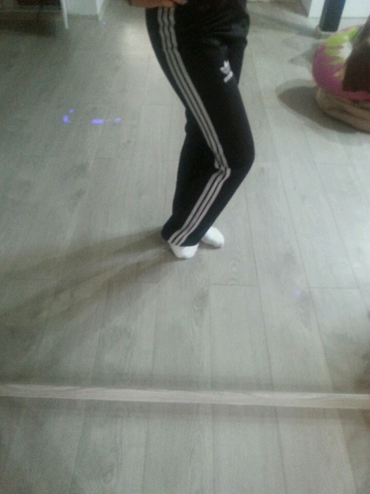 Girl in black/white Adidas pants