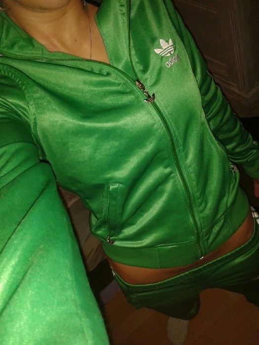 Girl in shiny green Adidas outfit