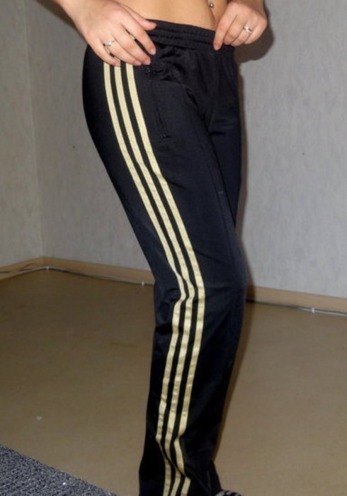 Girl with black/gold adidas pants
