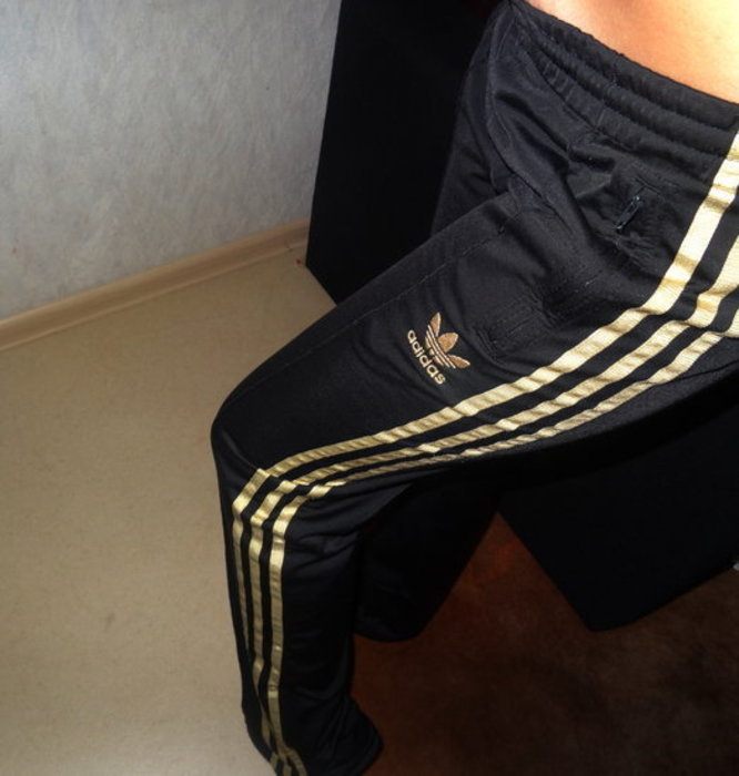 Girl with black/gold adidas pants
