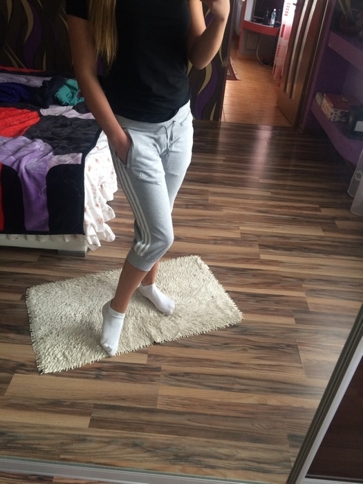 Girl with grey/white adidas pants