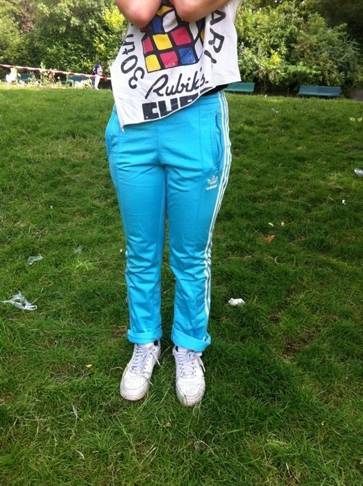 Girl with turquoise/white adidas pants