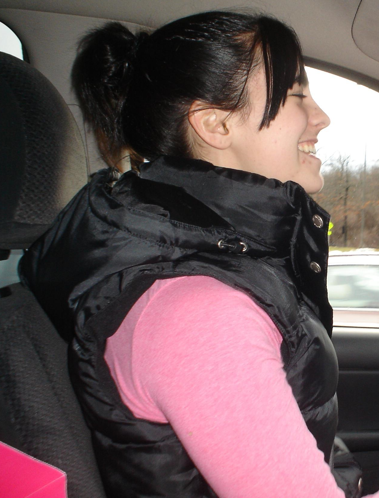 Hooded black gilet girl driving