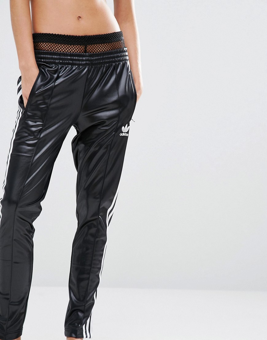 Hot blonde in Adidas Chile pants front close up
