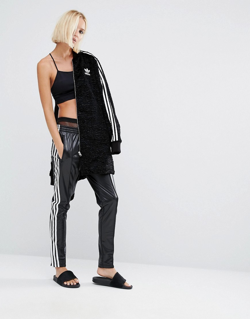 Hot blonde in Adidas Chile pants front view