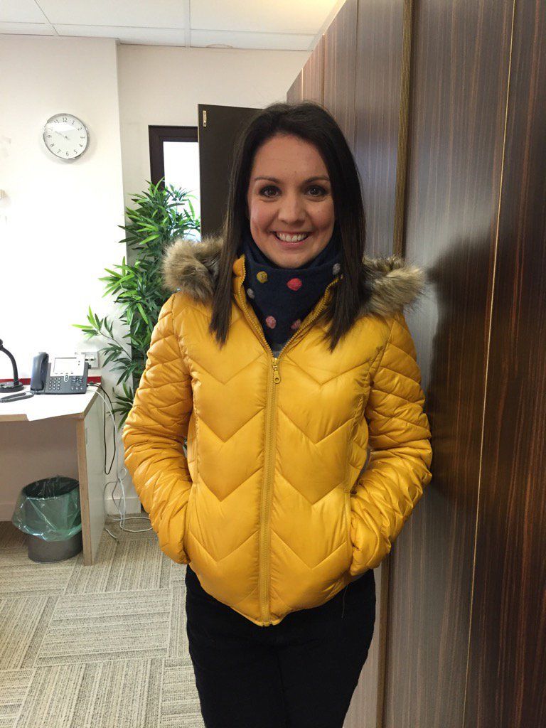 Laura Tobin yellow down jacket