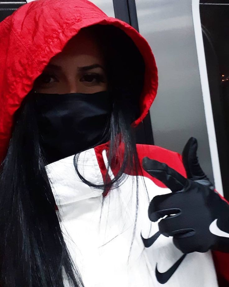 Masked girl showing her shiny nike gloves