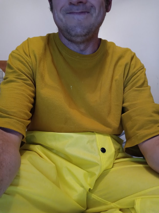 Me lounging around in my bedroom in my new yellow nylon pants (close-up)