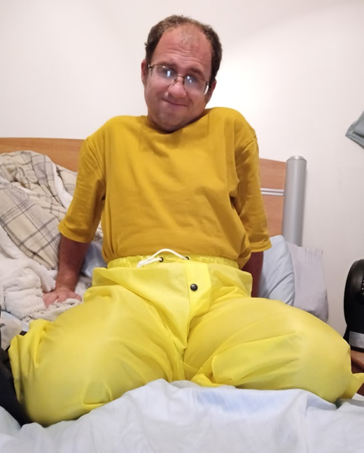 Me lounging around in my bedroom in my new yellow nylon pants (farther away)