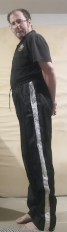 Me wearing my Large Black GTM Sportswear Polyester Pants (w/both hands behind my back) (side 1) 2