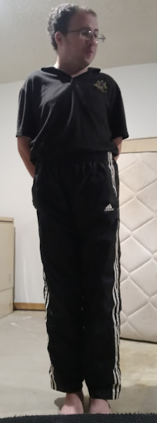 Me wearing my Small Black Adidas Nylon Pants with my hands behind my back 2