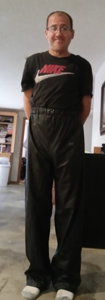 Me with my hands behind my back in my Black Shirt and Black Polyester Pants (front 2)