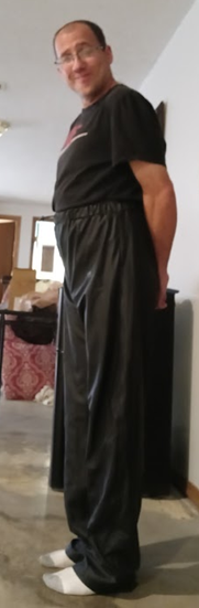 Me with my hands behind my back in my Black Shirt and Black Polyester Pants (side 2)