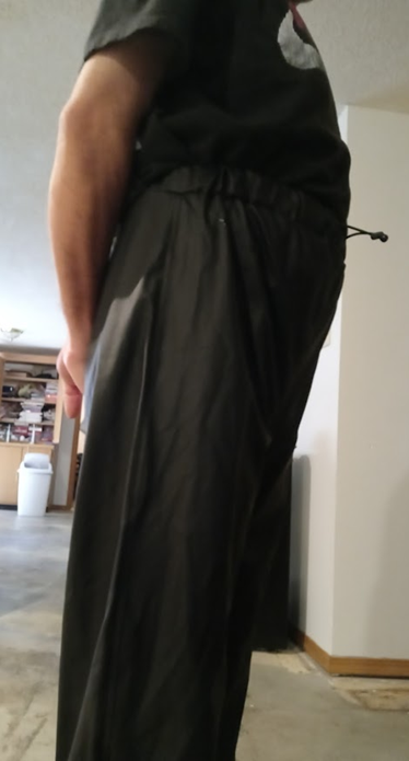 Me with my hands behind my back in my Black Shirt and my Black Polyester Pants (side 3)