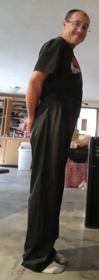 Me with my hands behind my back in my Black Shirt and my Black Polyester Pants (side 4)