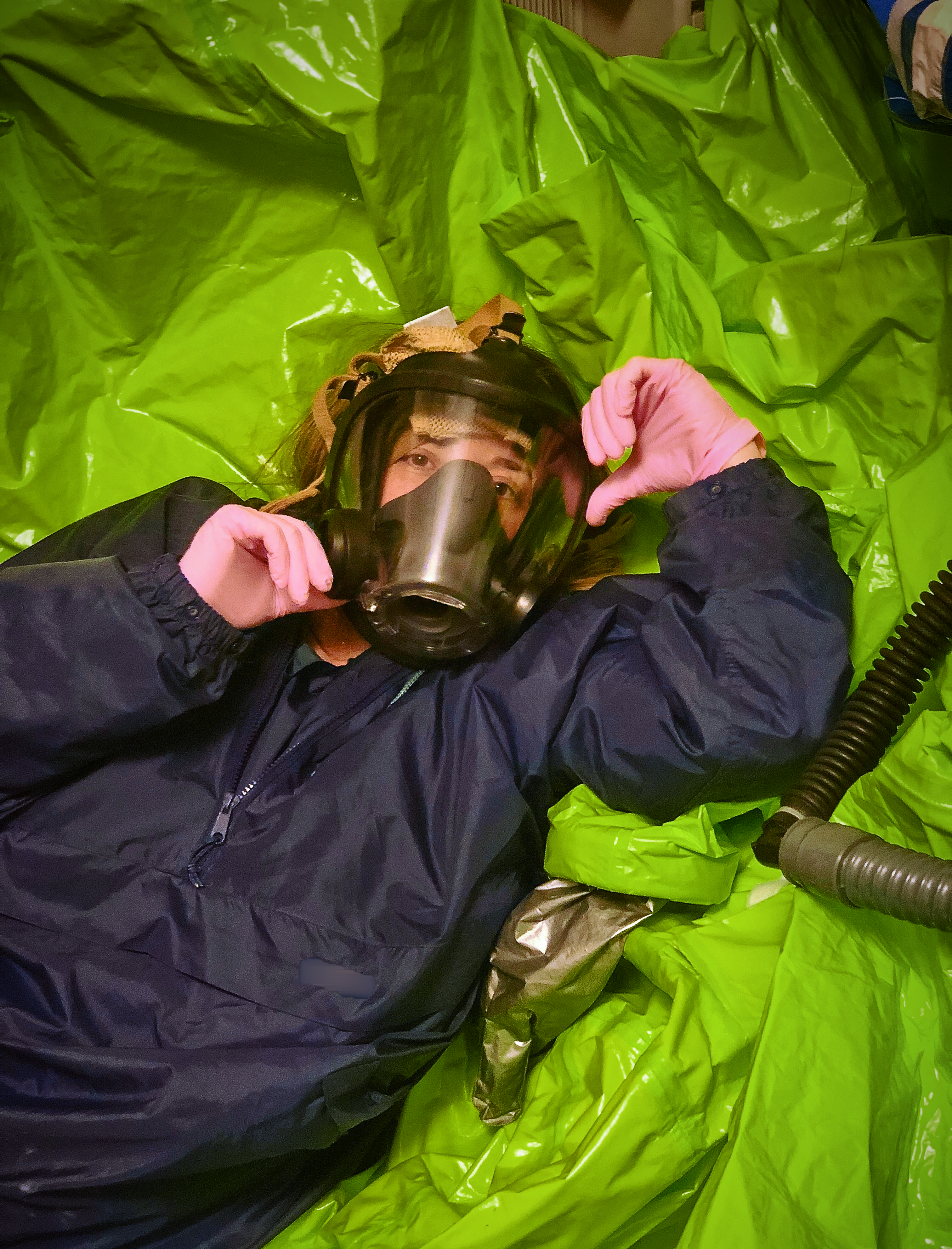 nylon rainsuit and a pile of hazmat suits