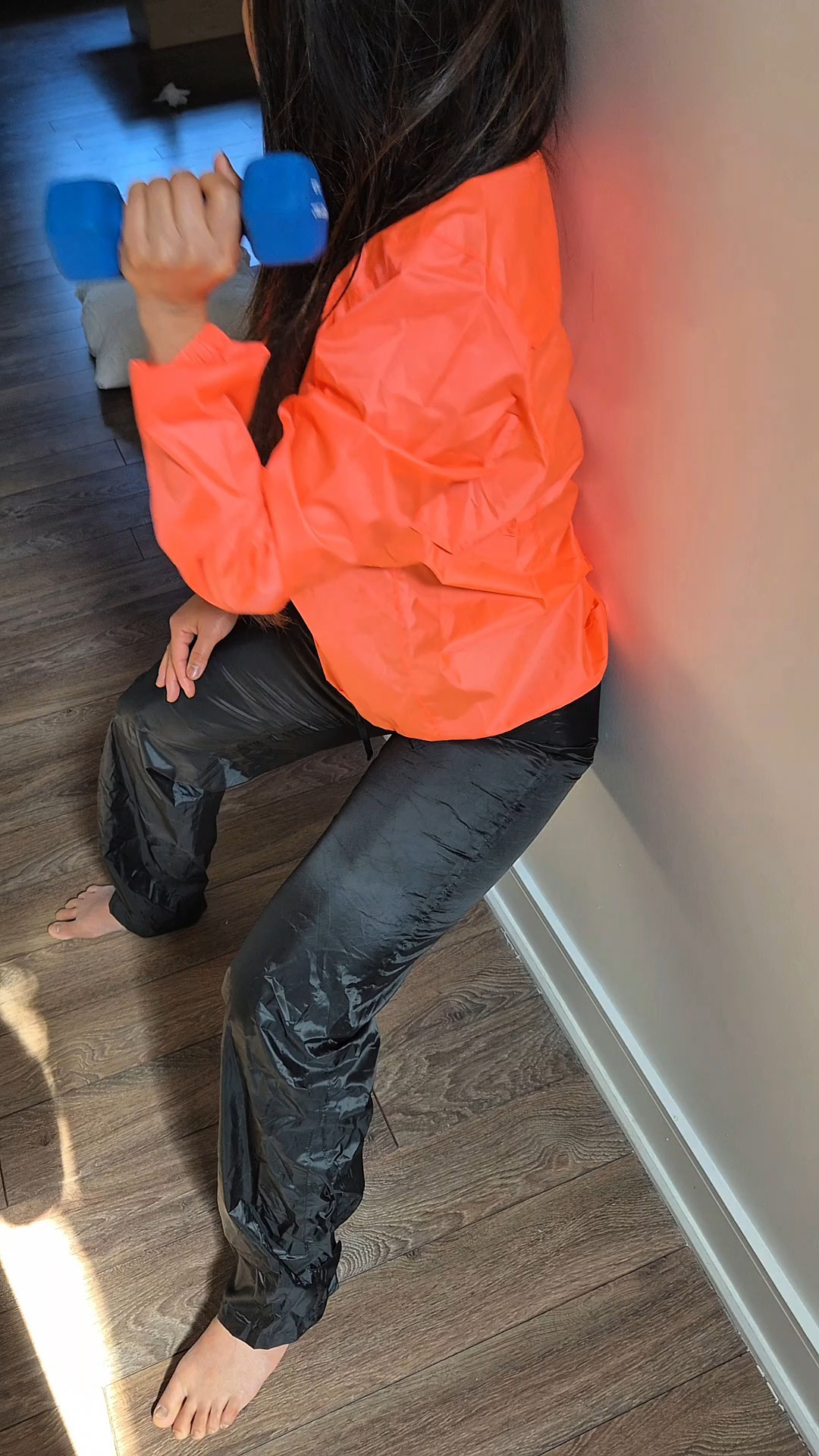 Orange rainjacket with shiny wetlook nylon pants