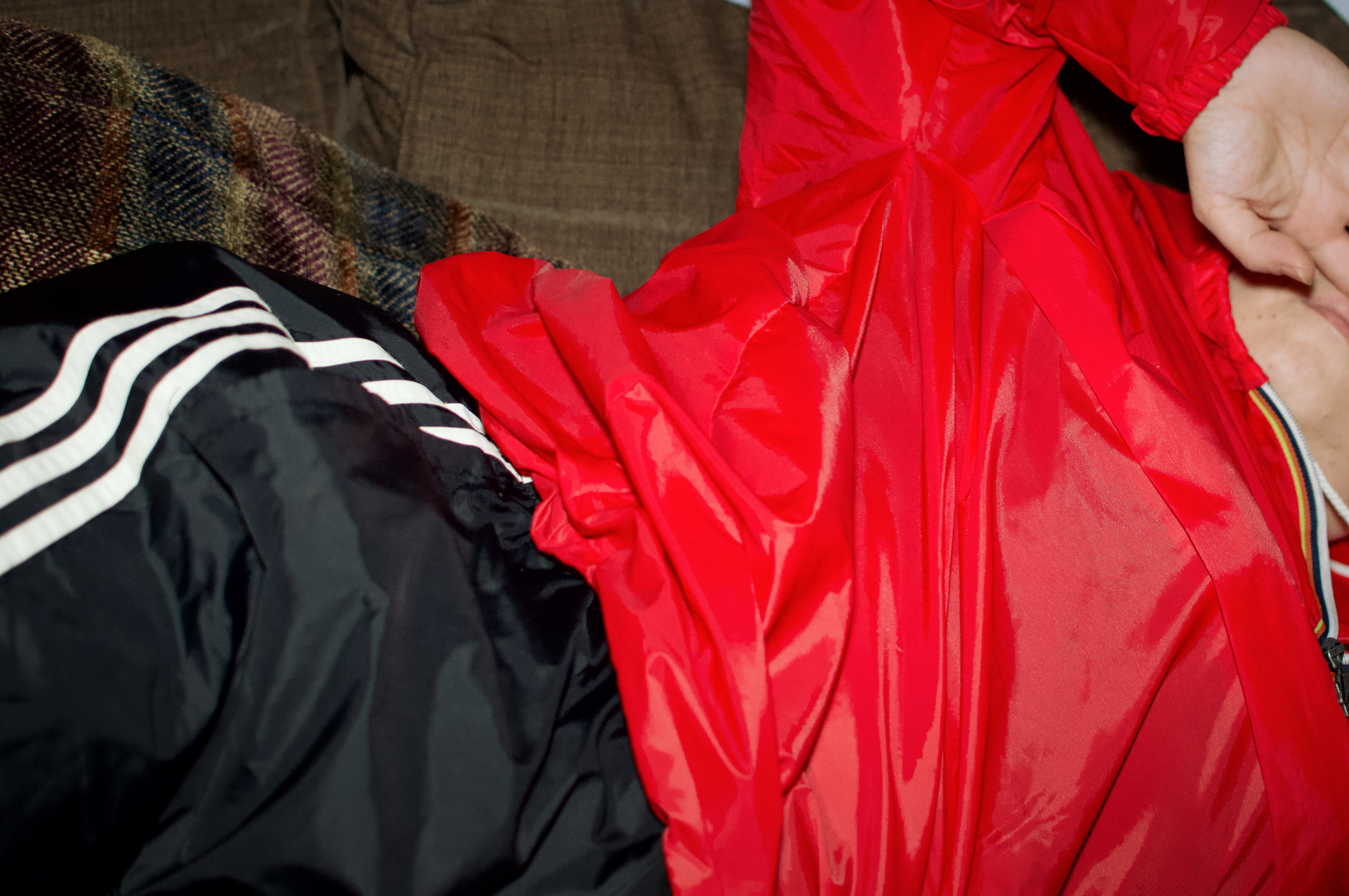 Red K-way pullover and black adidas pants