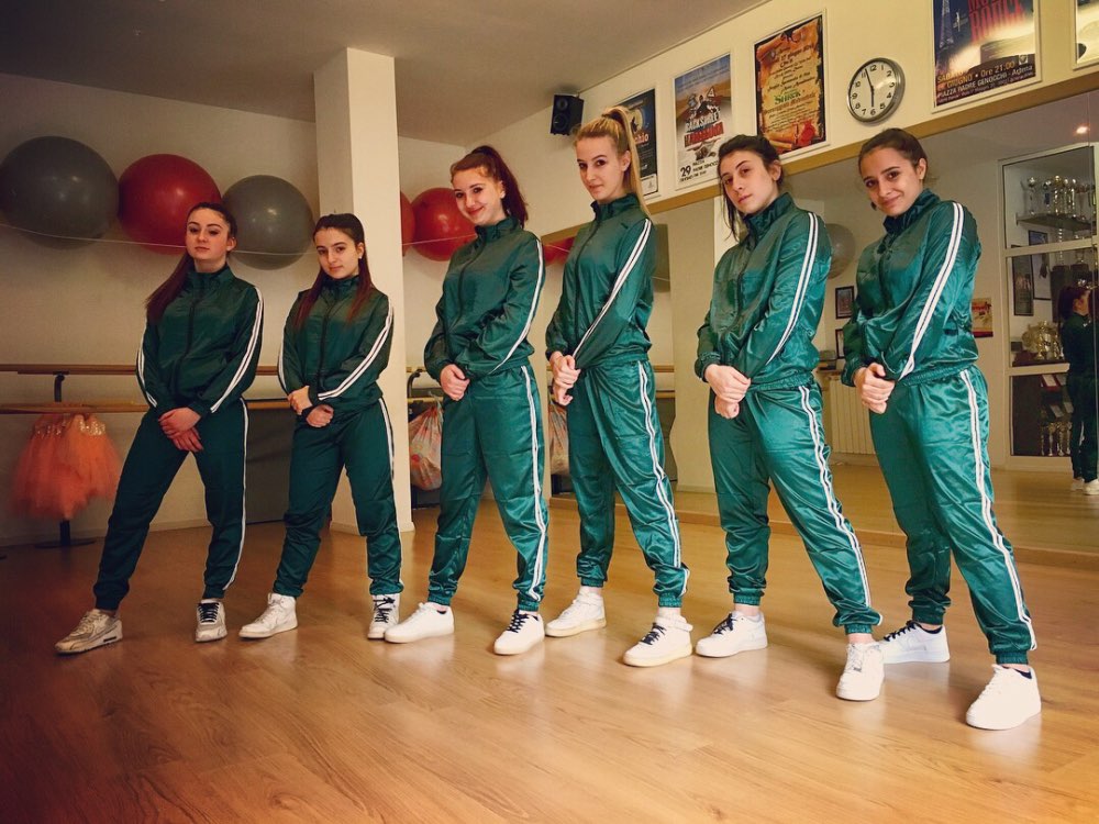 Six girls in green suits