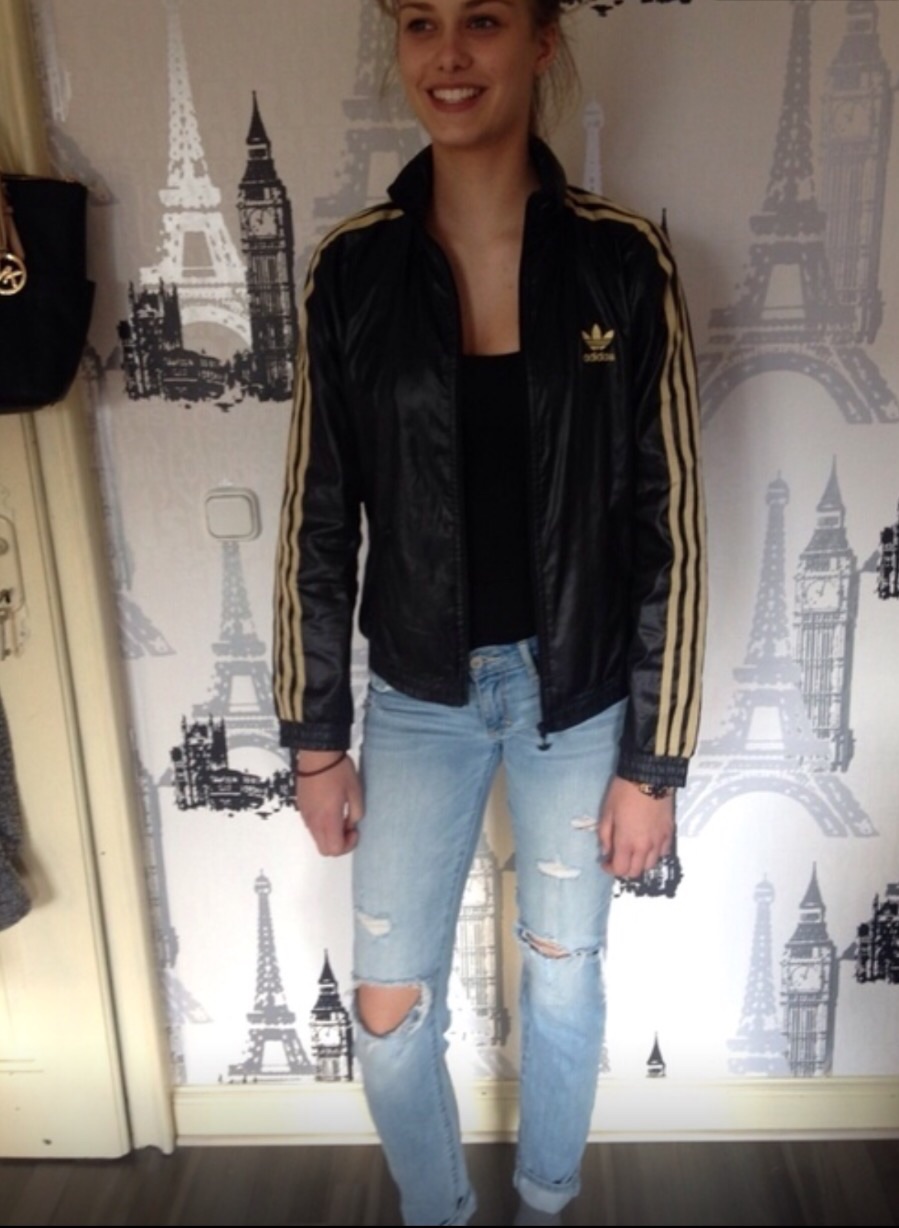 Skinny Girl wearing Adidas black and gold windbreaker Jacket
