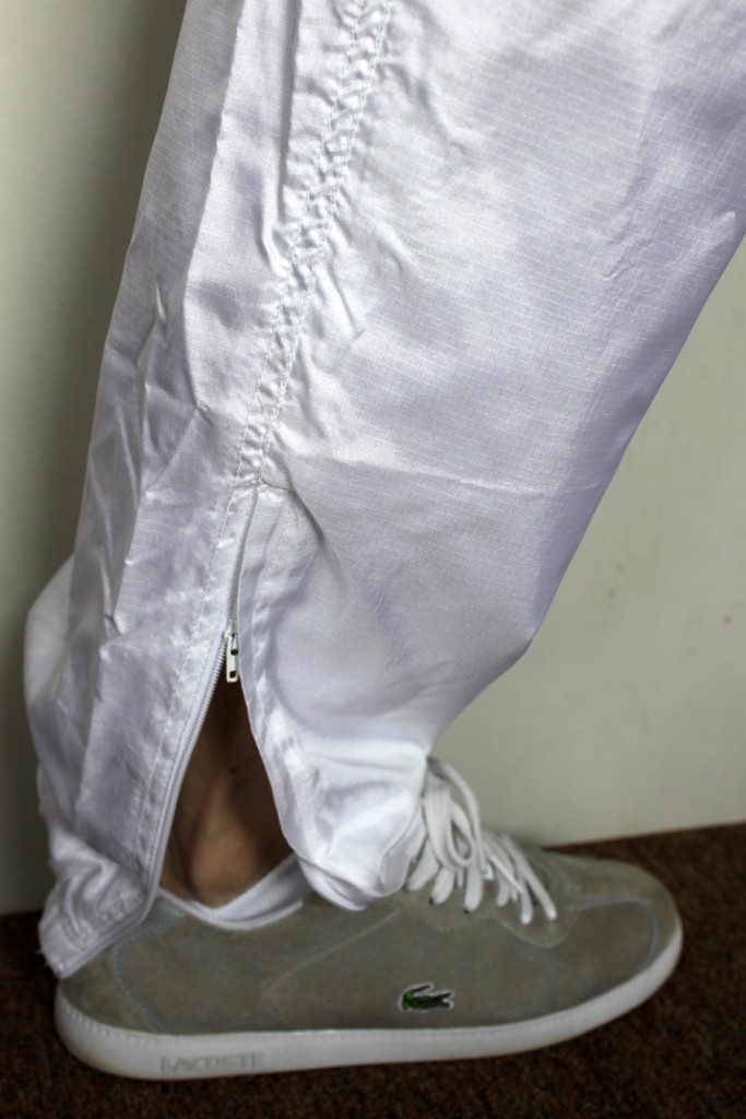 Woman in blue and white Nike shellsuit, foot shot