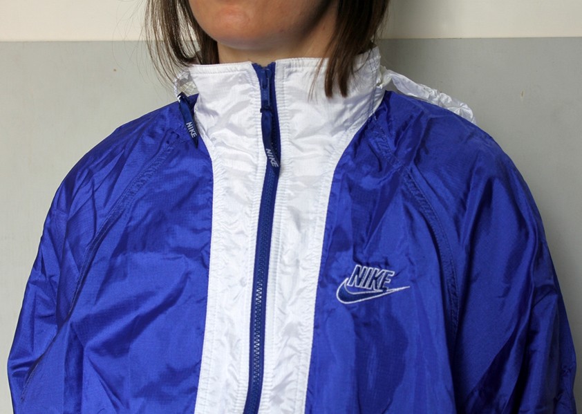 Woman in blue and white Nike shellsuit, front shot