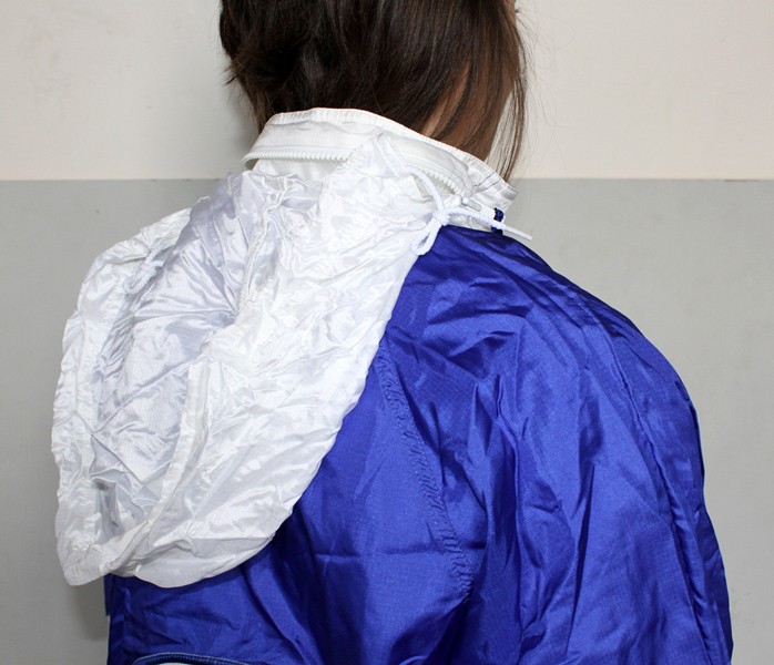 Woman in blue and white Nike shellsuit, hood