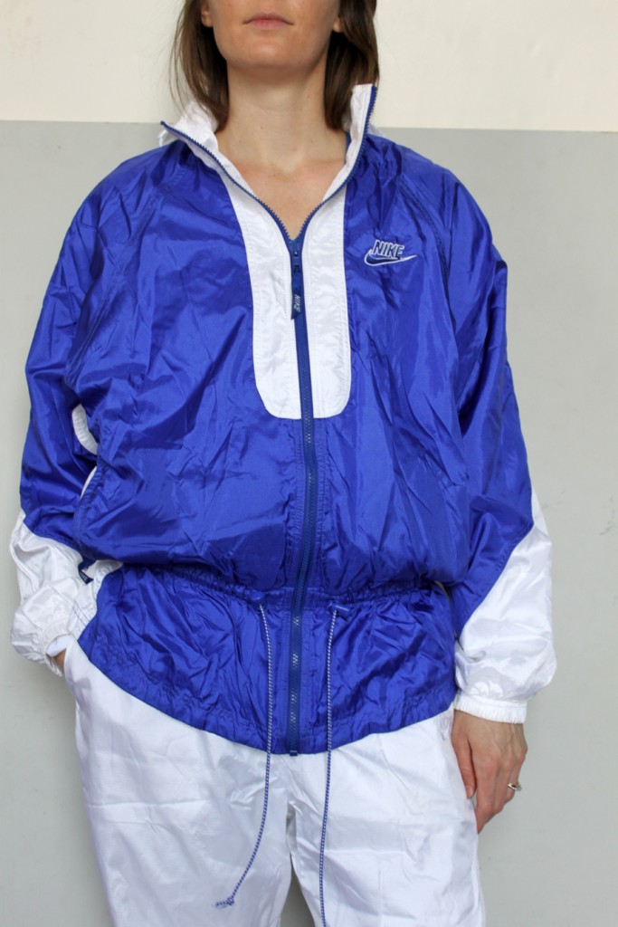 Woman in blue and white Nike shellsuit, top shot