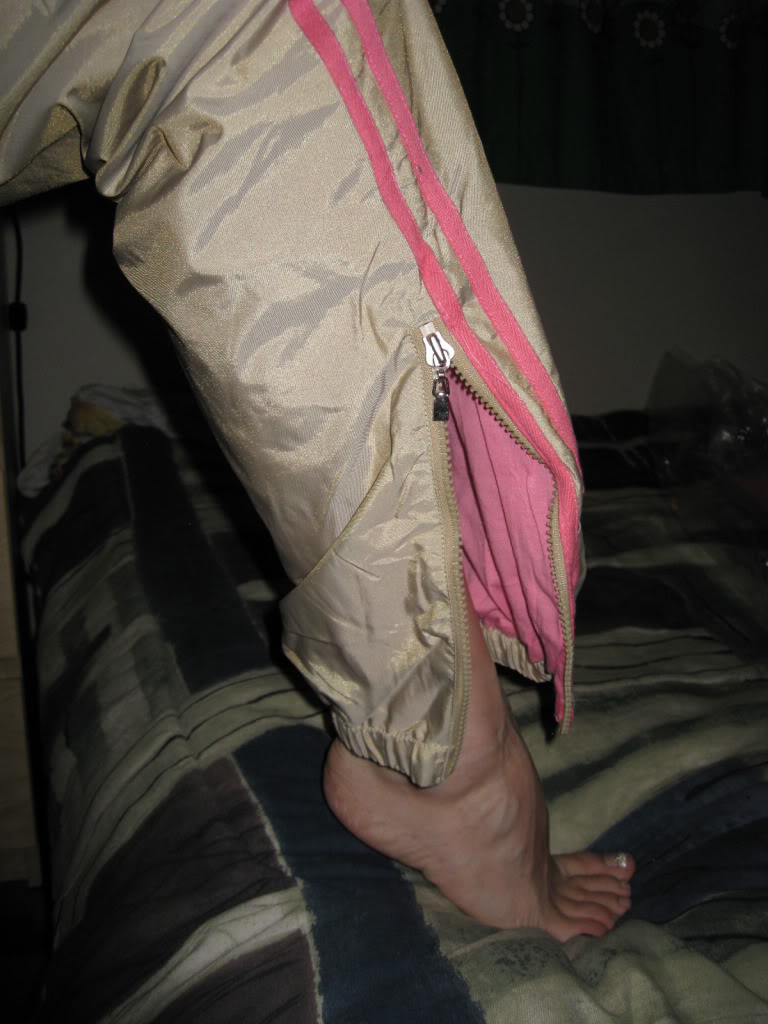 Woman wearing tan and pink shellsuit, foot shot