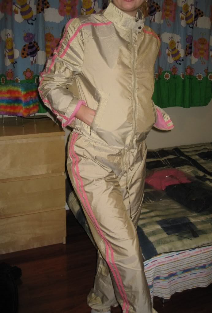 Woman wearing tan and pink shellsuit, front shot